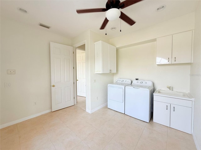 clothes washing area featuring separate washer and dryer, sink, cabinets, light tile patterned floors, and ceiling fan