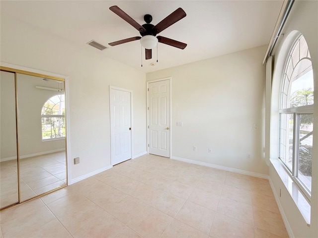 unfurnished bedroom with ceiling fan and light tile patterned floors