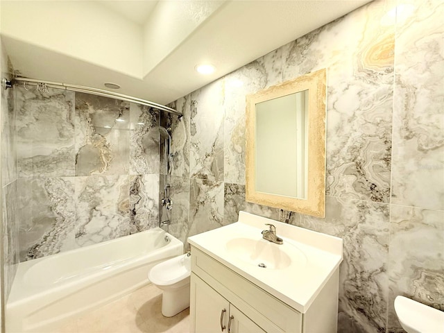 full bathroom featuring tiled shower / bath combo, vanity, tile walls, and toilet