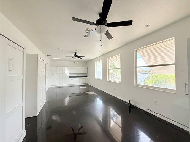 unfurnished living room featuring a textured ceiling