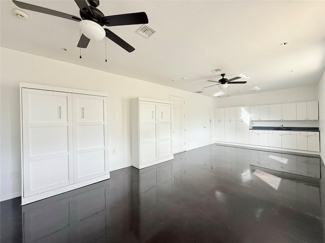 unfurnished living room with ceiling fan