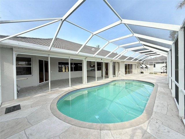 view of swimming pool with a lanai and a patio area