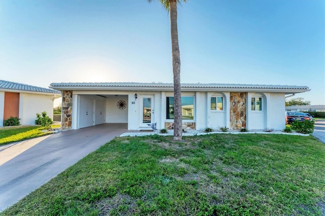 ranch-style home with a front yard and a carport