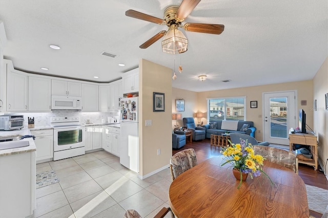 dining area featuring ceiling fan and light tile patterned flooring