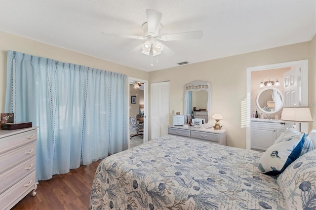 bedroom with dark hardwood / wood-style flooring, a closet, and ceiling fan