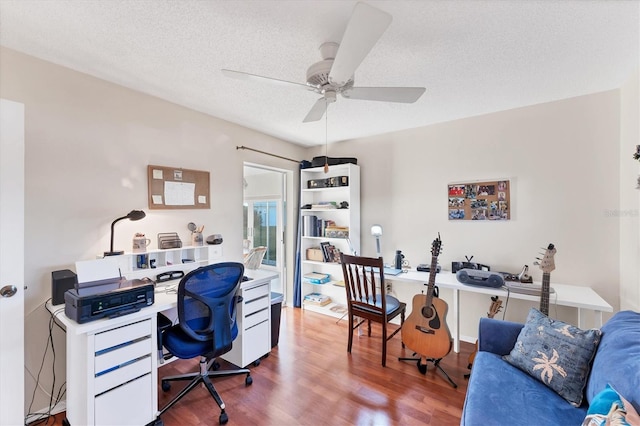 office space featuring wood-type flooring, a textured ceiling, and ceiling fan