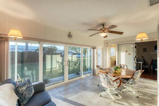 sunroom / solarium featuring a wealth of natural light and ceiling fan