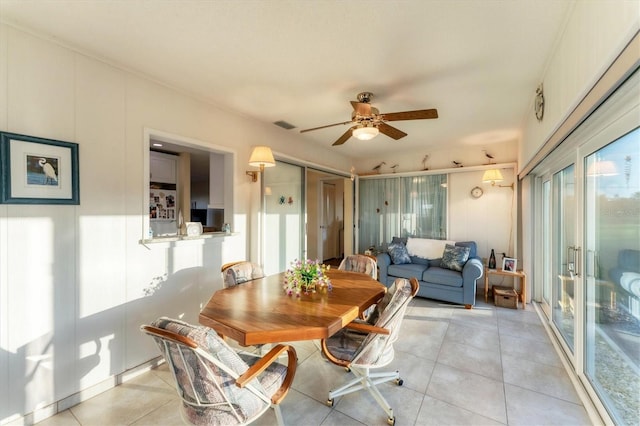 dining space featuring light tile patterned floors and ceiling fan