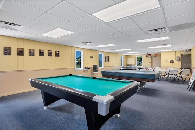 recreation room with dark carpet and a paneled ceiling