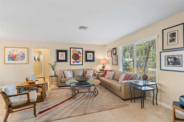 living room featuring light tile patterned floors and a textured ceiling