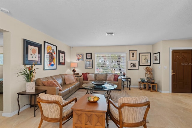 tiled living room featuring a textured ceiling