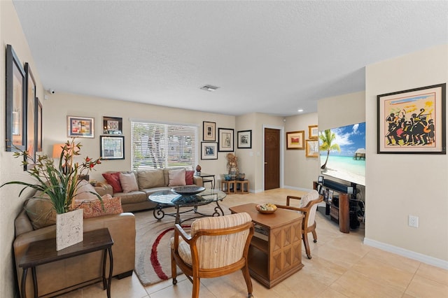 living room featuring light tile patterned floors and a textured ceiling