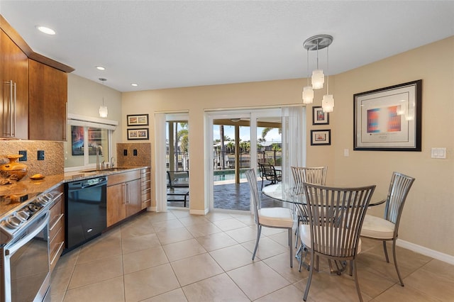 kitchen with hanging light fixtures, stainless steel electric range, light tile patterned floors, dishwasher, and decorative backsplash