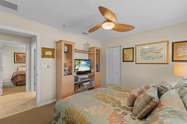 carpeted bedroom with ceiling fan and a closet