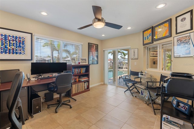 office area with light tile patterned floors and ceiling fan