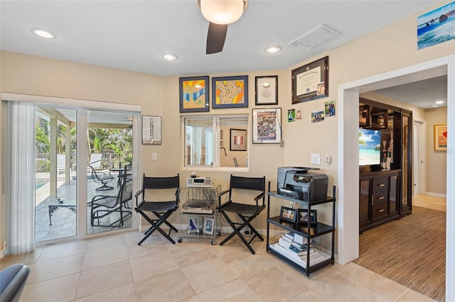 sitting room featuring light tile patterned floors and ceiling fan