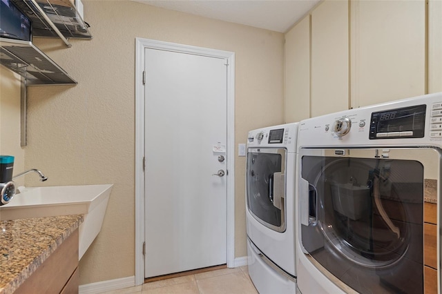 washroom featuring light tile patterned flooring and separate washer and dryer