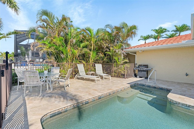 view of pool featuring a patio, a lanai, and area for grilling