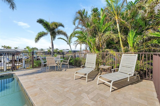 view of patio with a fenced in pool