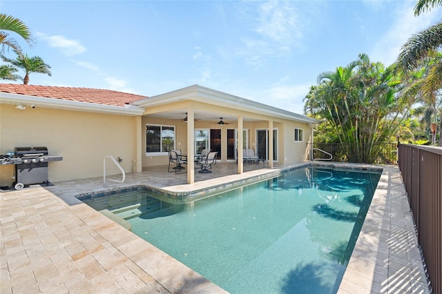 view of swimming pool featuring ceiling fan, grilling area, and a patio