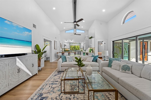 living area featuring light wood-type flooring, visible vents, and a wealth of natural light