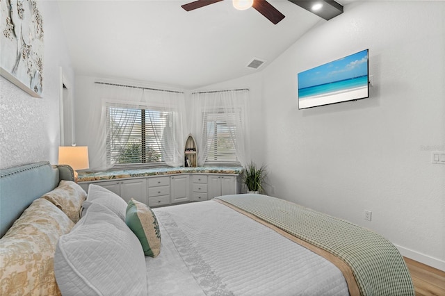 bedroom featuring visible vents, baseboards, vaulted ceiling, a ceiling fan, and light wood finished floors