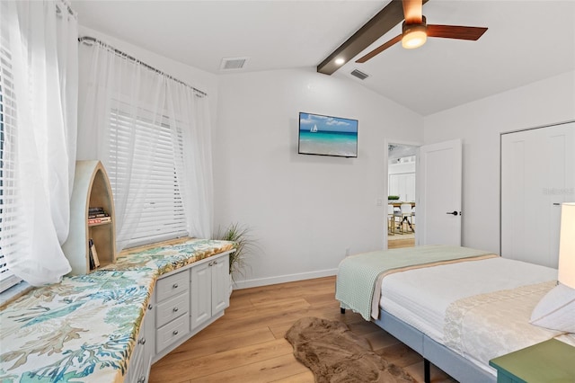 bedroom with lofted ceiling with beams, light wood finished floors, visible vents, and baseboards