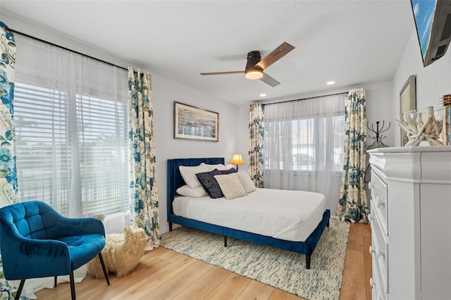 bedroom featuring ceiling fan, wood finished floors, and recessed lighting