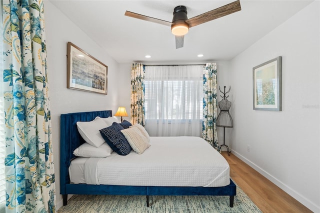 bedroom with a ceiling fan, recessed lighting, baseboards, and wood finished floors