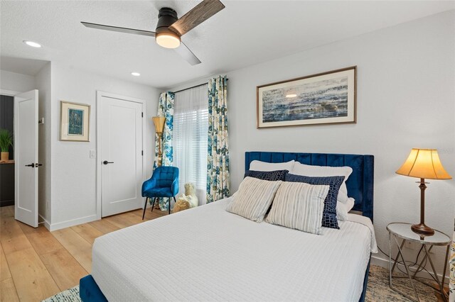 bedroom with recessed lighting, ceiling fan, baseboards, and wood finished floors