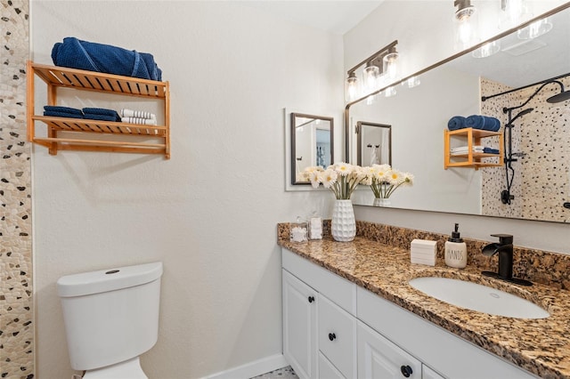 bathroom featuring baseboards, vanity, toilet, and walk in shower