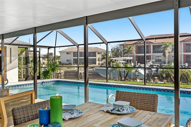 outdoor pool featuring a lanai, a residential view, and outdoor dining area