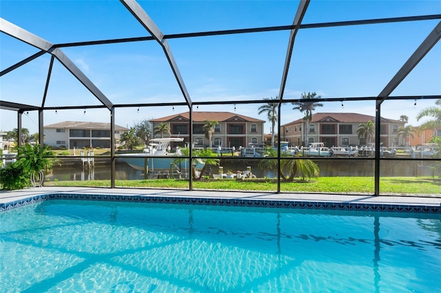 pool featuring a residential view, glass enclosure, and a water view