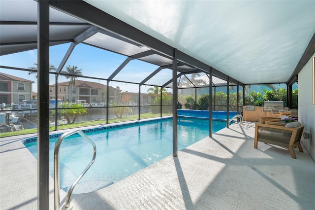 outdoor pool featuring glass enclosure, a patio, area for grilling, a water view, and a residential view