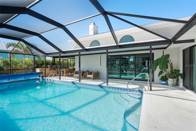 view of swimming pool with glass enclosure, a patio area, and a jacuzzi