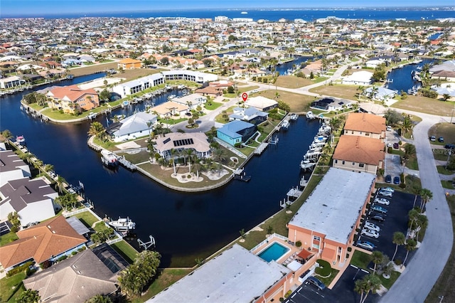 birds eye view of property with a water view and a residential view