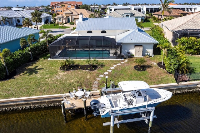 rear view of property featuring boat lift, a water view, a residential view, a lanai, and an outdoor pool