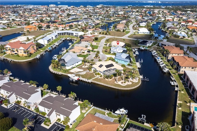 birds eye view of property featuring a water view and a residential view