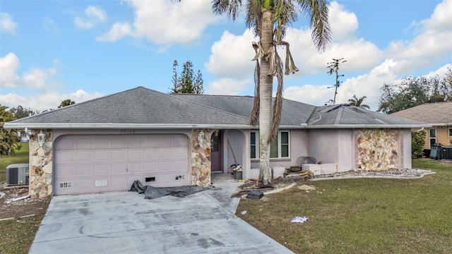 26166 Paysandu Dr, Punta Gorda, FL 33983 - ranch-style house featuring a garage, central AC unit, and a front lawn