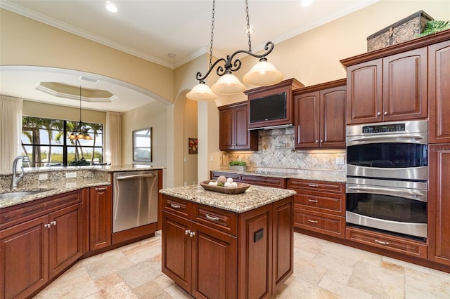 kitchen featuring tasteful backsplash, stainless steel appliances, decorative light fixtures, and sink