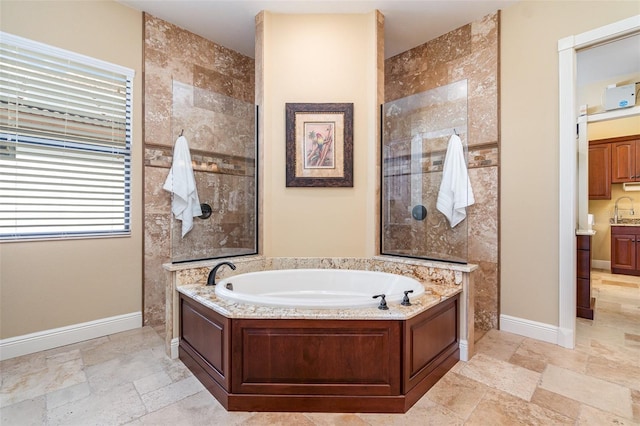 bathroom with vanity and independent shower and bath