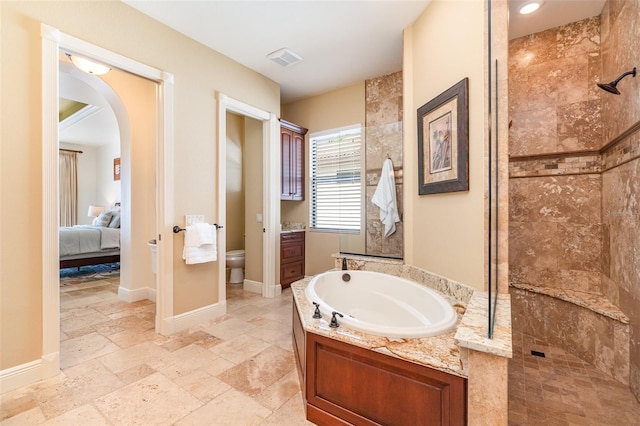 bathroom with toilet and plus walk in shower