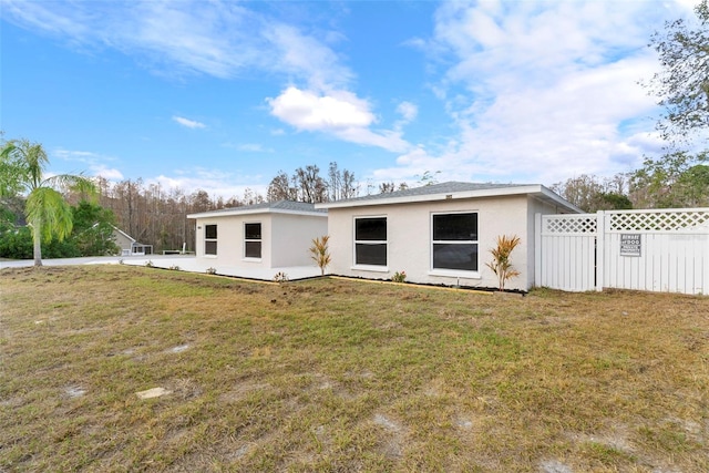 rear view of property with a yard