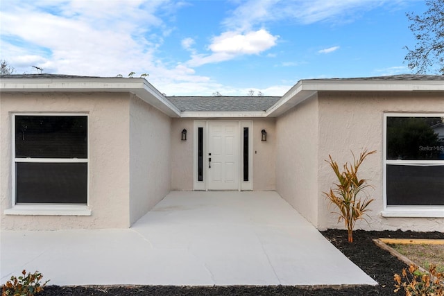 entrance to property featuring a patio area