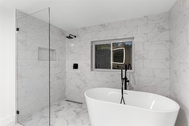 bathroom with tile walls and independent shower and bath