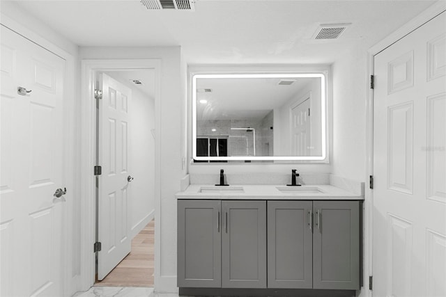 bathroom with vanity and a shower with shower door