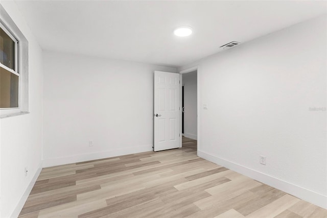 spare room featuring light hardwood / wood-style flooring