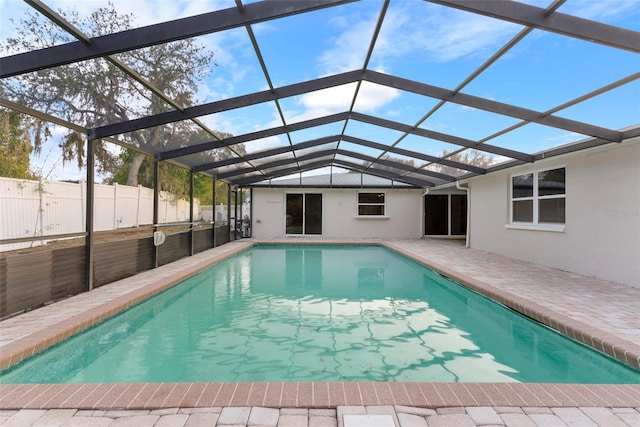 view of swimming pool with a patio and a lanai