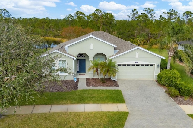 ranch-style house featuring a garage and a front lawn