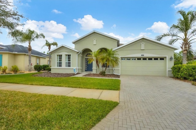 single story home featuring a garage and a front yard